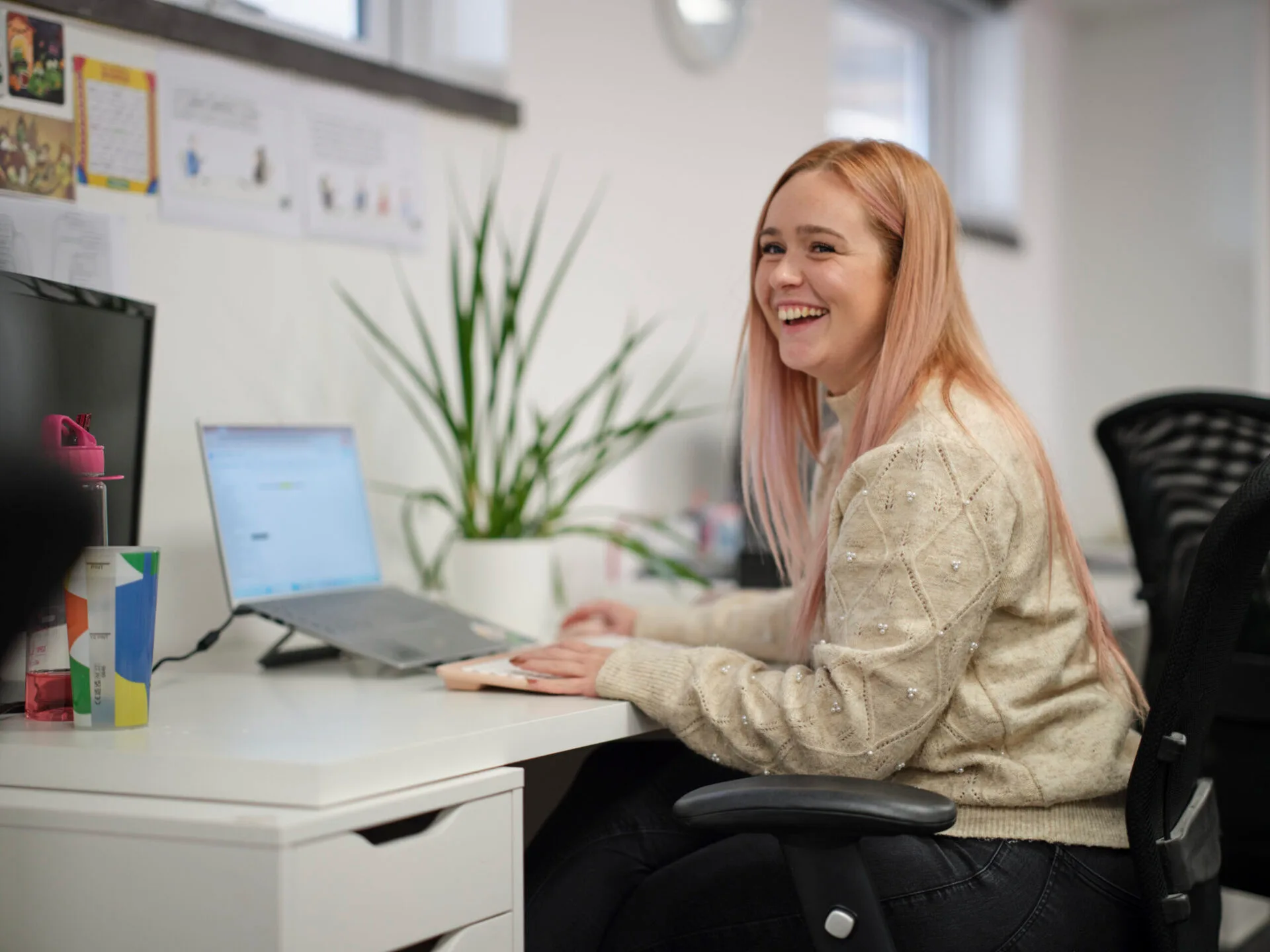 full colour Charlotte Black sitting at her desk in the Footprint Digital office
