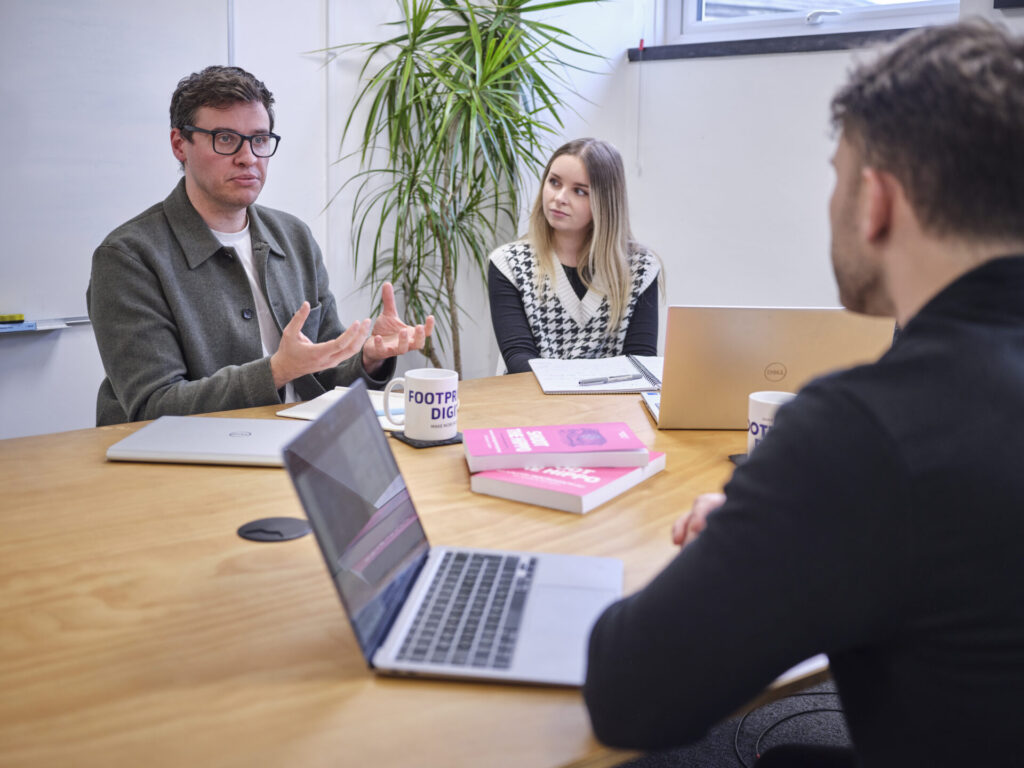 Full colour office shot meeting room 1 Tom C, Klaudia and team having a meeting