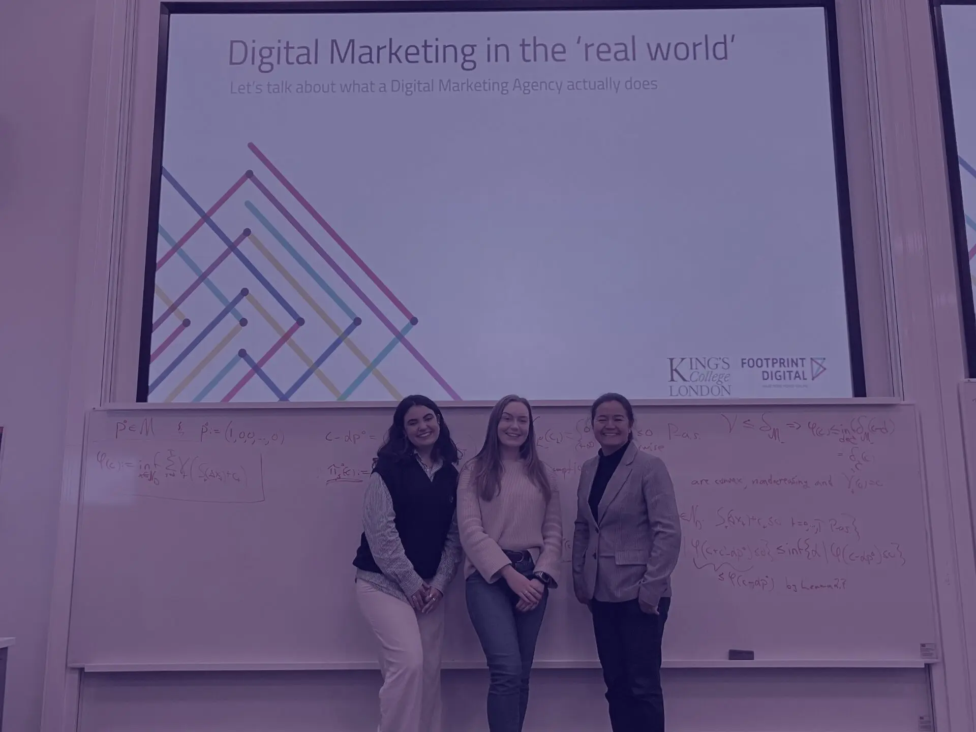 Purple university lecture - Kaya, Alex, and Sally in lecture room at Kings College London