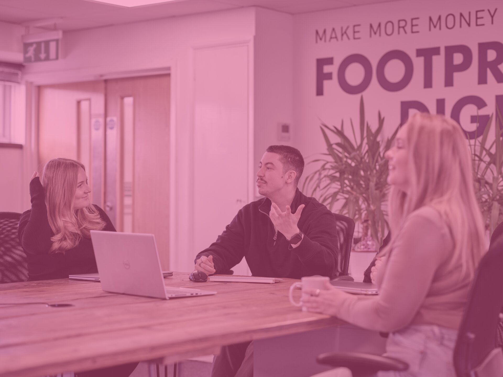 Kieran, Issy, and Charlotte in main office with pink image overlay