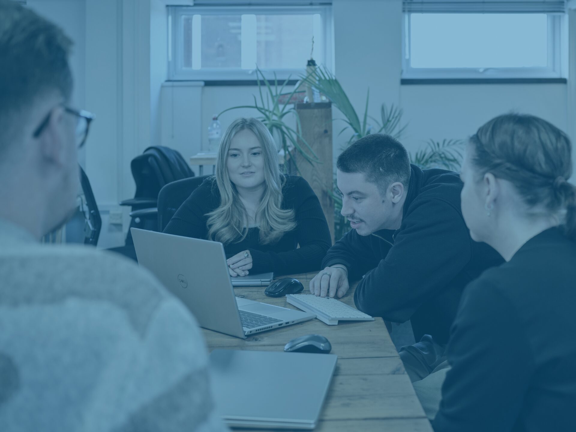 The kierans, Issy and crystal in main office with blue image overlay