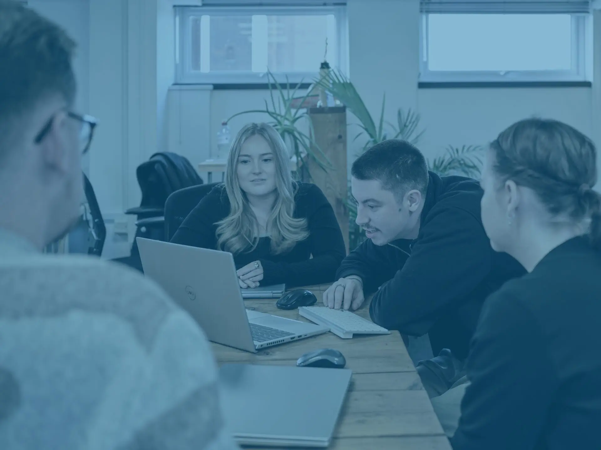 The kierans, Issy and crystal in main office with blue image overlay