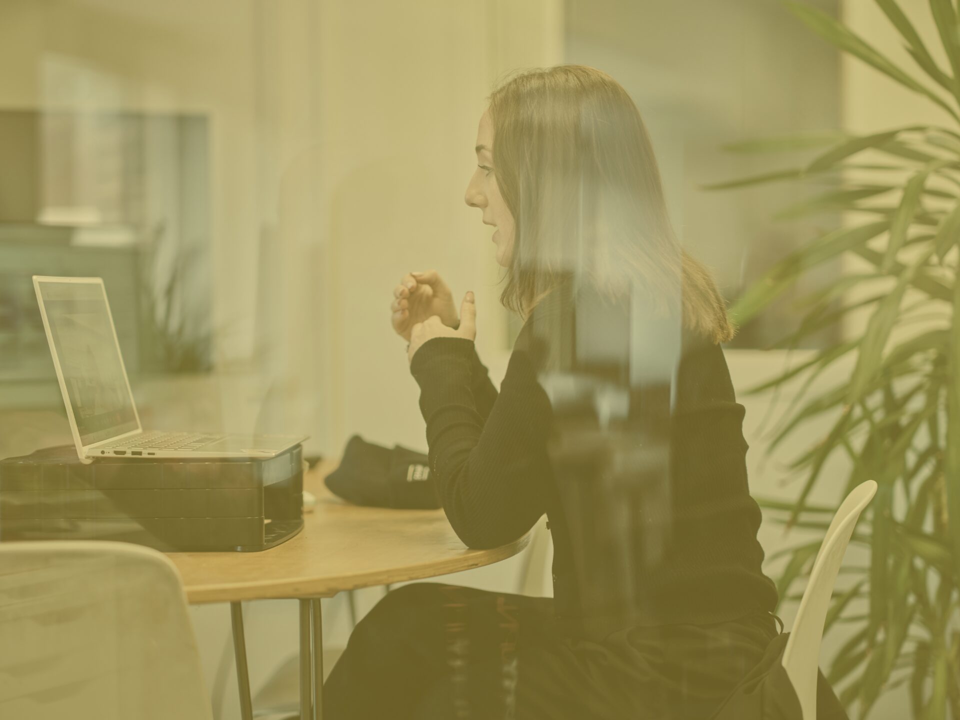 Rosie on a call in office meeting room with yellow image overlay
