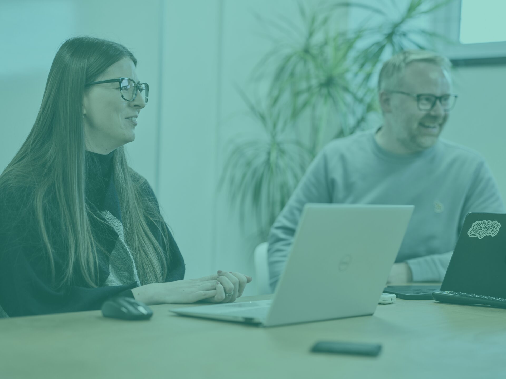 charlotte and sam in office meeting room with teal image overlay