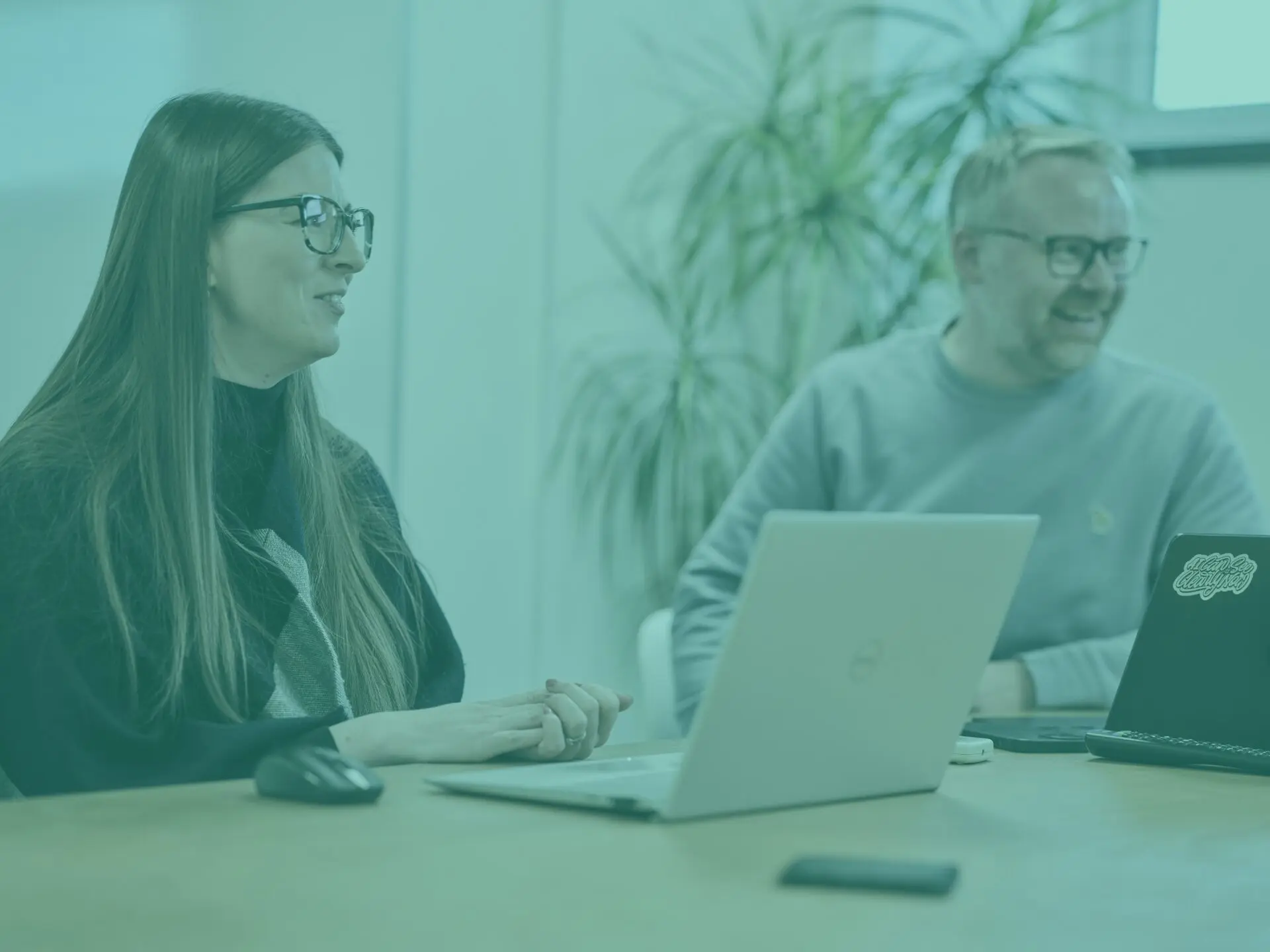charlotte and sam in office meeting room with teal image overlay