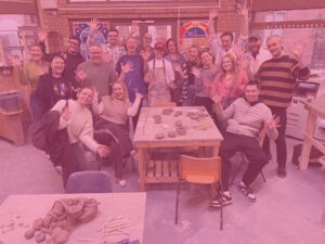 Whole team photo at pottery apprentice challenge pink image overlay
